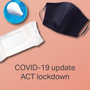 Image of desk with mask, wipes and hand sanitiser. Text saying COVID-19 update ACT lockdown