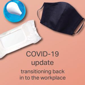 Image of desk with text saying COVID-19 update transitioning back to work